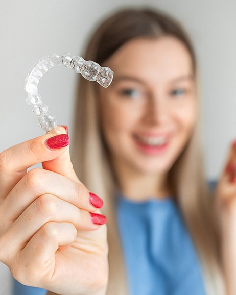 Patient in Amityville smiling with Invisalign