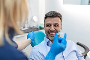 Patient in Amityville smiling with orthodontist at Invisalign check-in