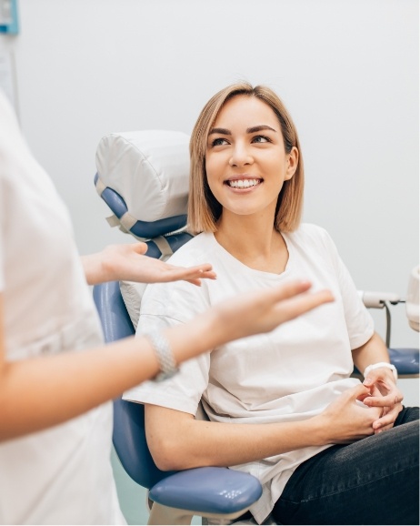 Woman smiling while listening to her orthodontist