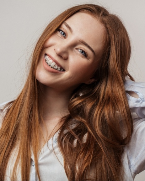 Teenage girl with clear braces smiling