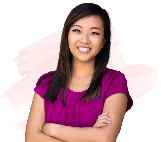 Woman in magenta blouse smiling with arms crossed