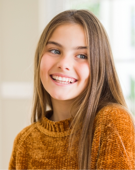 Smiling young woman in orange sweater