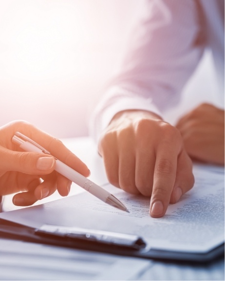 Two people looking at paperwork on clipboard