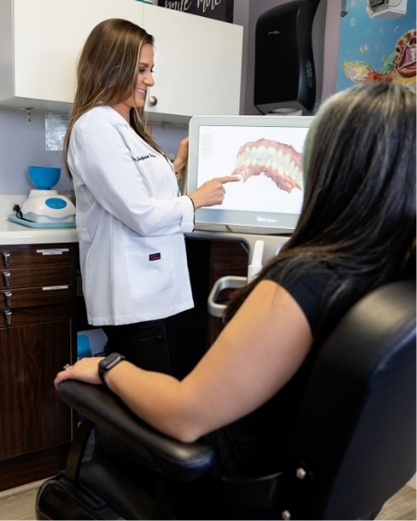 Doctor Justyna showing a patient digital scans of their teeth