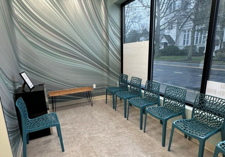 Row of blue chairs in waiting area