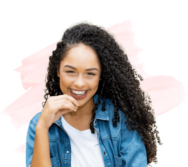 Young woman in denim jacket smiling with traditional braces in Amityville